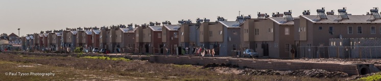 An attempt to improve Cape Towns housing crisis with cheap apartments on the edge of the shanty town.